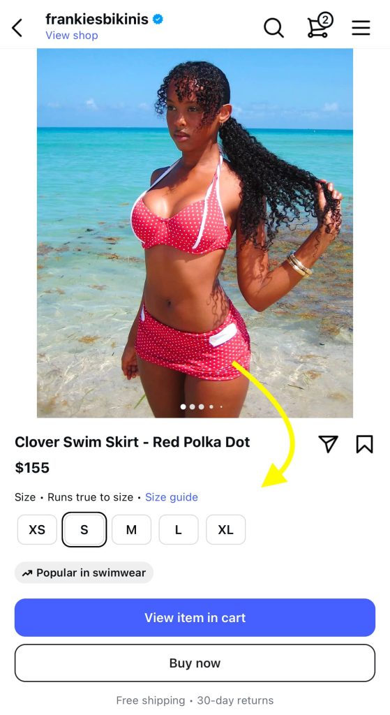 Person holding a smartphone displaying a shoppable content post on Instagram, with product tags enabling direct in-app purchasing.